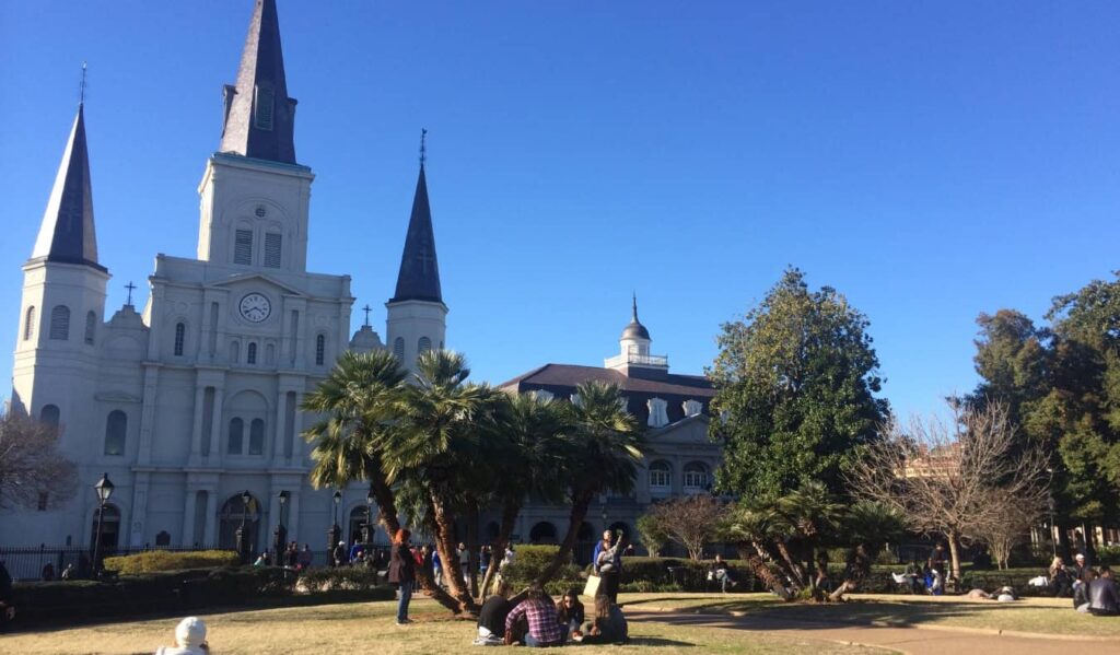 The white St Louis Cathedral in grassy Jackson Square in New Orleans, Louisiana